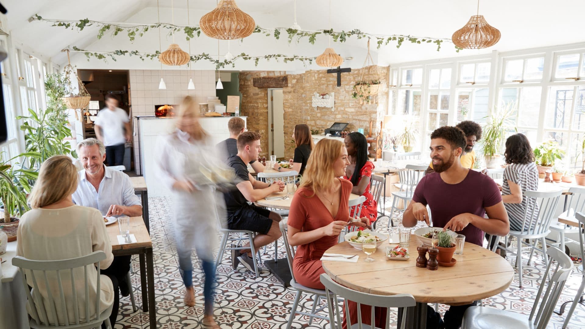 Restaurant owner greeting new customers at the door